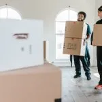 Movers carrying moving boxes